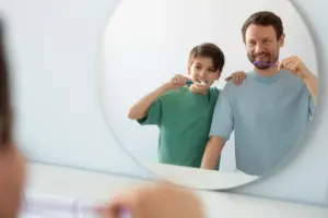 man and child presenting healthy oral hygiene